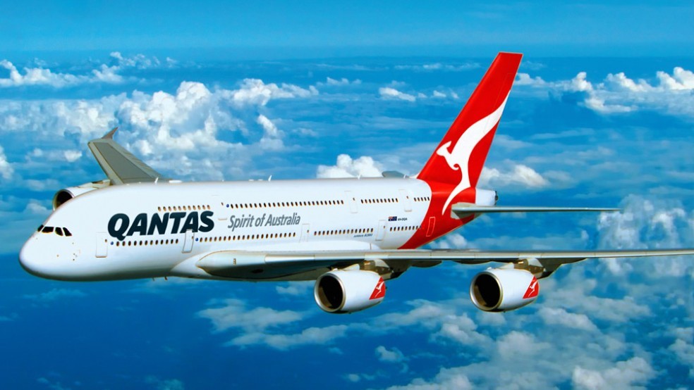 A Qantas aircraft against a blue sky and clouds