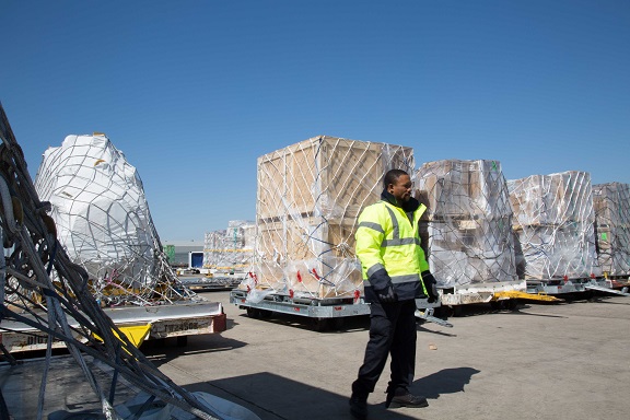 Cargo worker on the tarmac with pallets