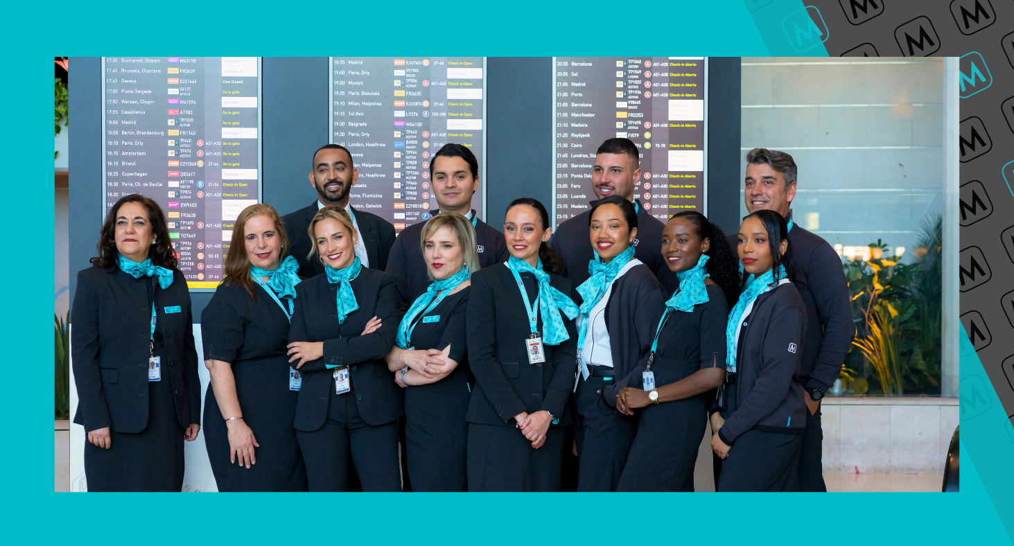 Colleagues in Lisbon smile for a photo as they model our new Front of House uniform