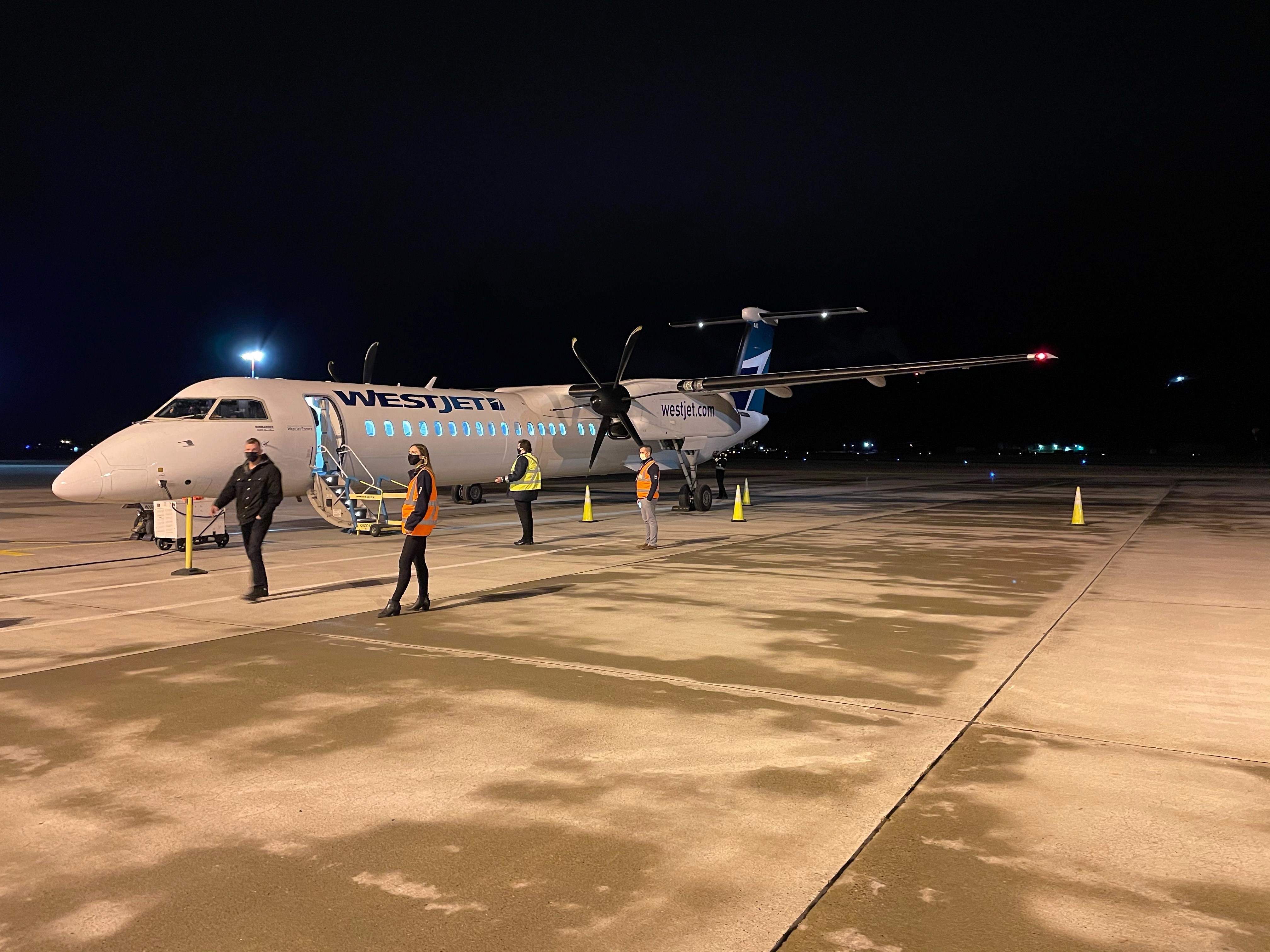 Menzies employees with WestJet plane at Kamloops