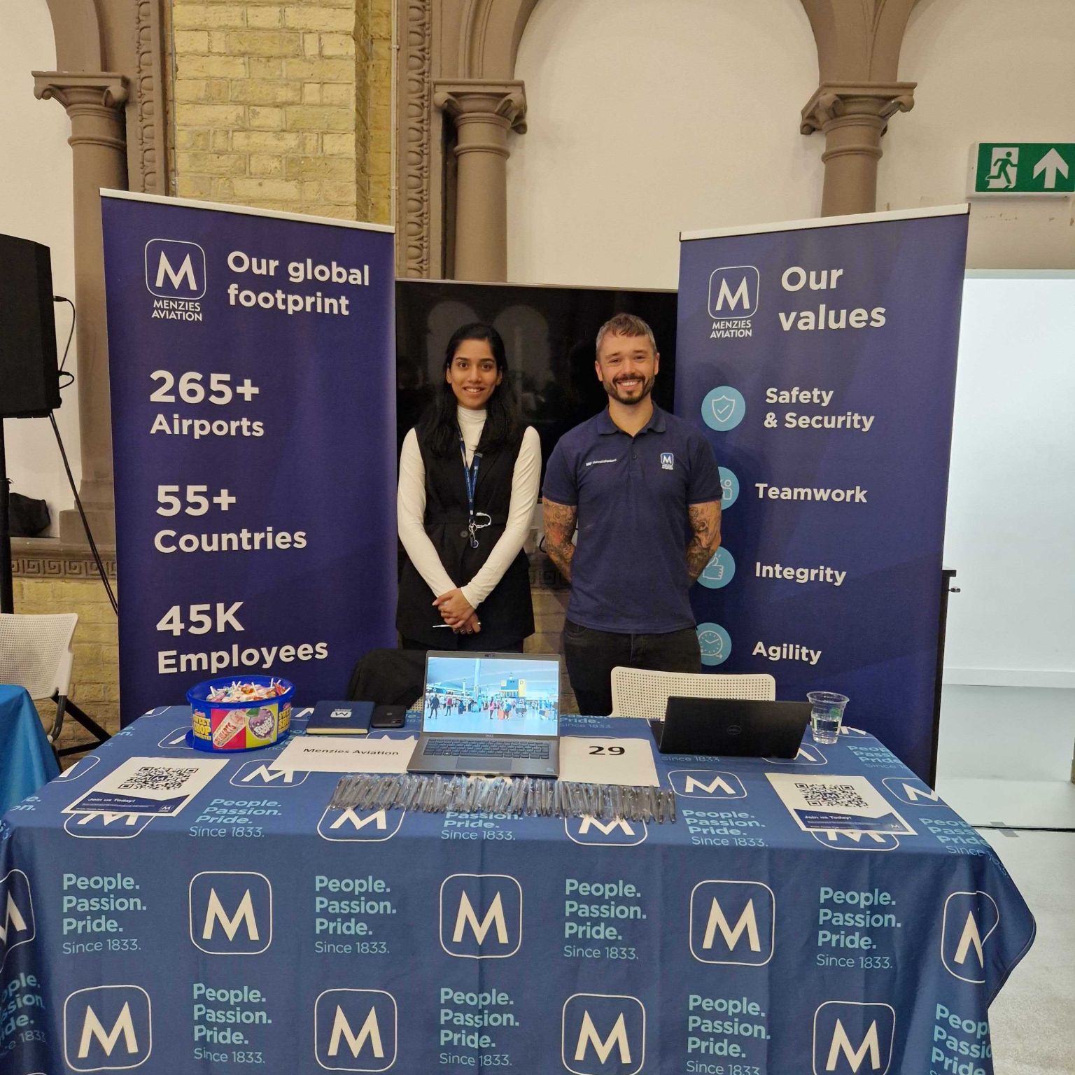 Ash Clark and Shambhavi Sale at a Menzies branded desk