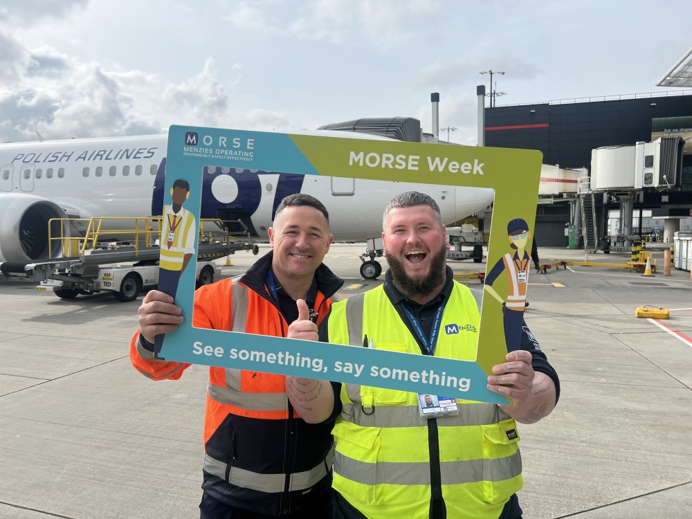 London Heathrow colleagues holding a MORSE Week frame on the ramp