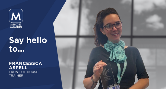 Francessca smiles while holding a glass trophy from the Aviation Heroes event. Francessca smiles while holding a glass trophy from the Aviation Heroes event.